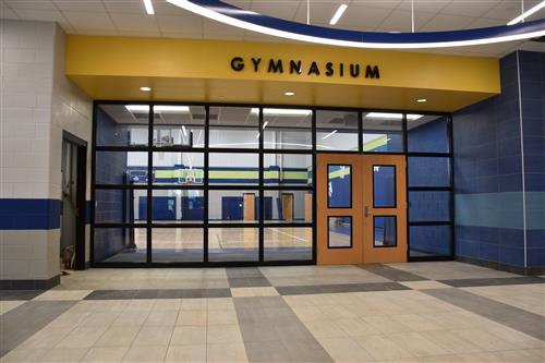 Gym entrance doors flanked by glass panels